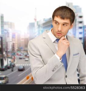 business, architecture and building concept - pensive man