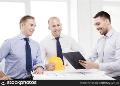 business, architecture and office concept - happy team of architects and designers in office