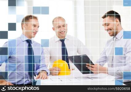 business, architecture and people concept - happy team of architects and designers in office over squared grid background