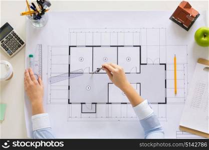 business, architecture, building and construction concept - architect hands with compass measuring blueprint of living house at office. hands with compass measuring blueprint at office