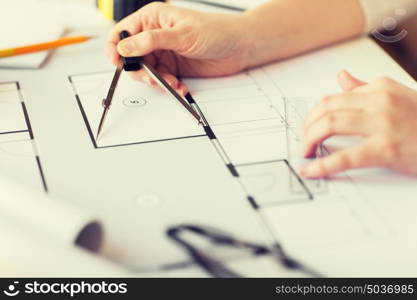 business, architecture, building, construction and people concept - close up of architect hands with compass measuring living house blueprint. close up of hands with compass measuring blueprint