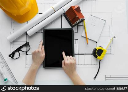 business, architecture, building, construction and people concept - close up of architect hand with living house blueprint and tablet pc computer