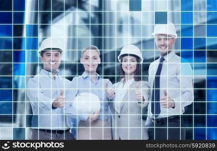 business, architecture, teamwork, gesture and office concept - happy team of architects in office showing thumbs up over blue squared grid background