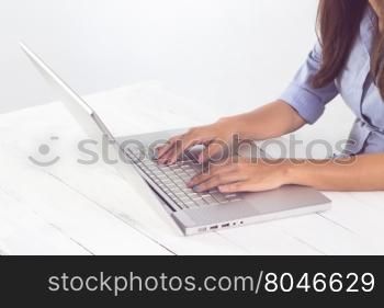 Business asian woman hand typing on laptop keyboard at workplace