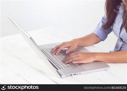 Business asian woman hand typing on laptop keyboard at workplace