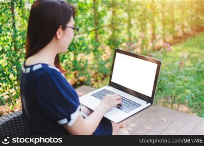 ?Business Asian woman working with laptop computer on office outdoor.