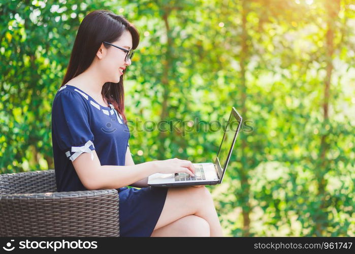 Business Asian woman working with laptop computer on office outdoor.