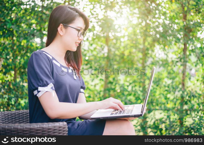 Business Asian woman working with laptop computer on office outdoor.