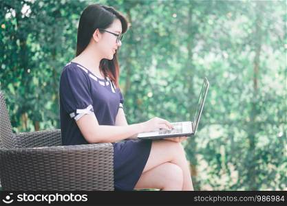 Business Asian woman working with laptop computer on office outdoor.