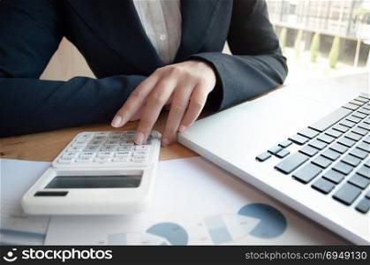 business audit woman using calculator - finance and valuation concept