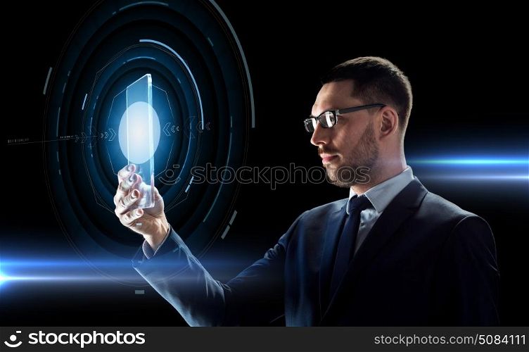 business, augmented reality and future technology concept - businessman in glasses working with transparent tablet pc computer and hologram over black background. businessman working with transparent tablet pc. businessman working with transparent tablet pc