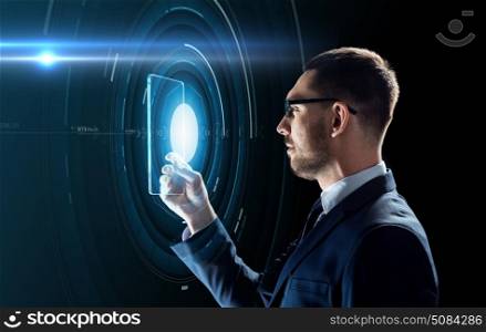 business, augmented reality and future technology concept - businessman in glasses working with transparent tablet pc computer and hologram over black background. businessman working with transparent tablet pc. businessman working with transparent tablet pc
