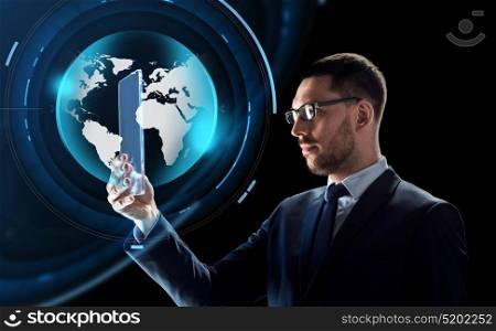business, augmented reality and future technology concept - businessman in glasses working with transparent tablet pc computer and virtual earth globe hologram over black background. businessman with tablet pc and virtual globe