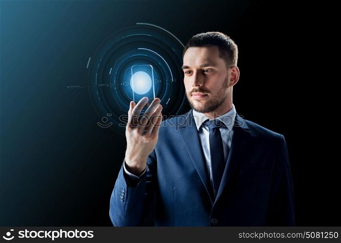 business, augmented reality and future technology concept - businessman in suit working with transparent smartphone and hologram over black background. businessman with transparent smartphone