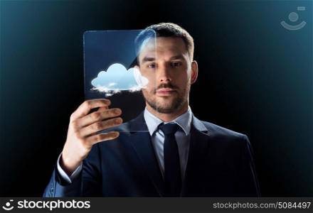 business, augmented reality and future technology concept - businessman in suit working with transparent tablet pc computer over black background. businessman working with transparent tablet pc. businessman working with transparent tablet pc