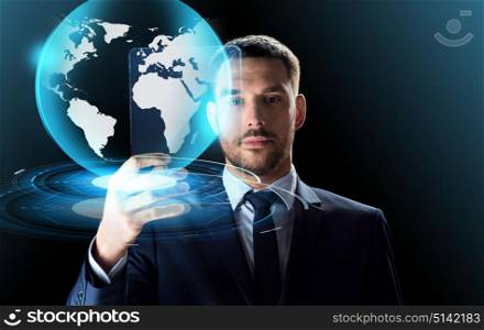 business, augmented reality and future technology concept - businessman in suit working with transparent tablet pc computer and virtual earth globe hologram over black background. businessman with tablet pc and virtual globe