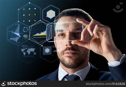 business, augmented reality and future technology concept - businessman in suit working with transparent smartphone and virtual charts projection over black background. businessman with transparent smartphone