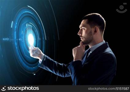 business, augmented reality and future technology concept - businessman in suit working with transparent tablet pc computer and hologram over black background. businessman working with transparent tablet pc