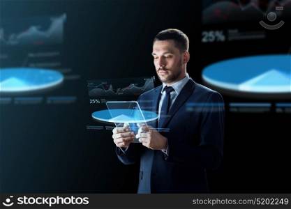 business, augmented reality and future technology concept - businessman in suit working with transparent tablet pc computer and virtual charts projections over black background. businessman with tablet pc and virtual charts