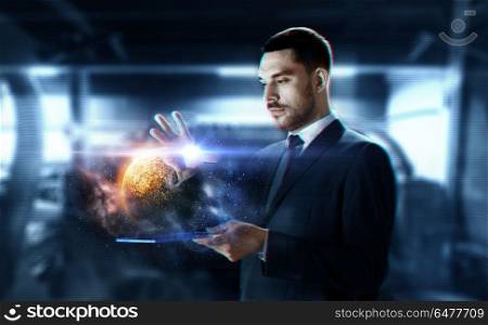 business, augmented reality and future technology concept - businessman in suit working with transparent tablet pc computer and hologram of planet and space over abstract background. businessman with transparent tablet and planet. businessman with transparent tablet and planet