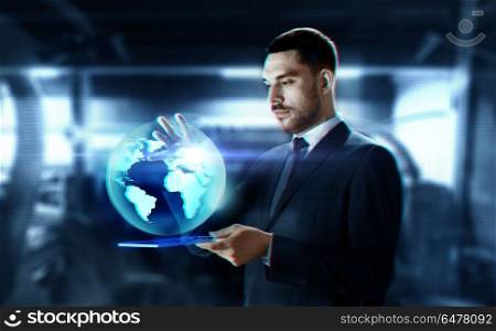 business, augmented reality and future technology concept - businessman in suit working with transparent tablet pc computer and earth hologram over abstract background. businessman with transparent tablet and earth. businessman with transparent tablet and earth