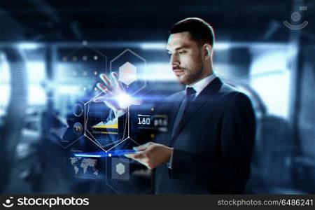 business, augmented reality and future technology concept - businessman in suit working with transparent tablet pc computer and hologram of charts over abstract background. businessman with transparent tablet and charts. businessman with transparent tablet and charts