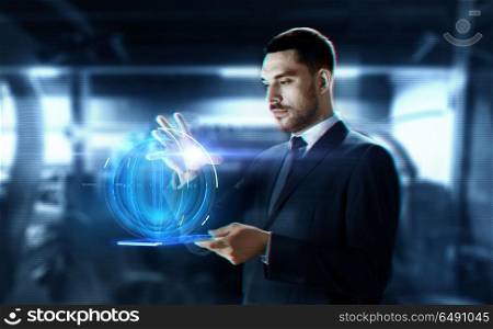 business, augmented reality and future technology concept - businessman in suit working with transparent tablet pc computer and hologram over abstract background. businessman with transparent tablet and hologram. businessman with transparent tablet and hologram