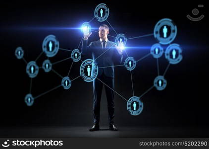 business, augmented reality and human resources concept - businessman with virtual network contacts over black background. businessman with virtual network contacts