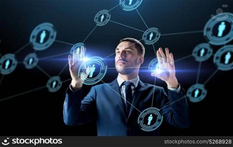 business, augmented reality and human resources concept - businessman with virtual network contacts over black background. businessman with virtual network contacts