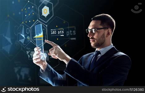 business, augmented reality and modern technology concept - businessman in glasses working with transparent tablet pc computer and virtual charts projection over black background. businessman working with transparent tablet pc