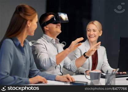 business, augmented reality and technology concept - developers with singapore city on virtual headset or 3d glasses screen working late at night office. developers with virtual reality headset at office. developers with virtual reality headset at office