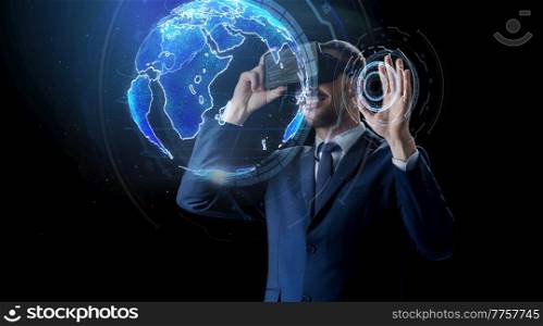 business, augmented reality and technology concept - happy smiling businessman in vr glasses with virtual earth planet projection over black background. businessman in virtual reality headset over black
