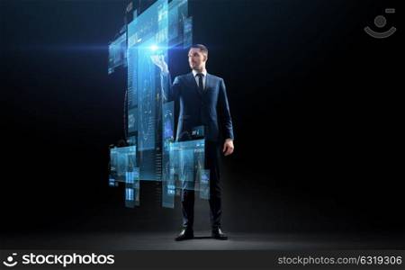 business, augmented reality, people and future technology concept - businessman in suit working with virtual screens projection over black background. businessman in suit with virtual projection