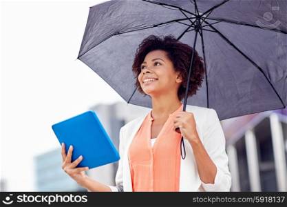business, bad weather and people and concept - happy african american businesswoman with umbrella and tablet pc computer at city street