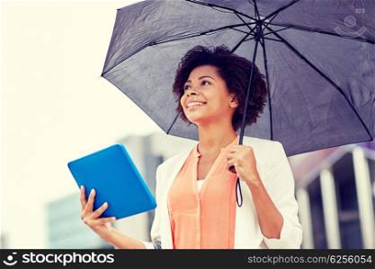 business, bad weather and people and concept - happy african american businesswoman with umbrella and tablet pc computer at city street