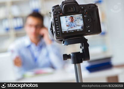 Business blogger doing webcast for his subscribers. The business blogger doing webcast for his subscribers