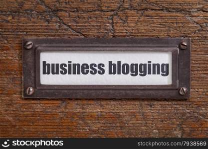 business blogging - file cabinet label, bronze holder against grunge and scratched wood