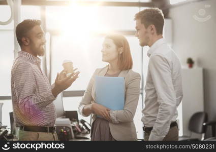 business, break, communication and people concept - happy creative team drinking coffee and talking at office. happy business team drinking coffee at office