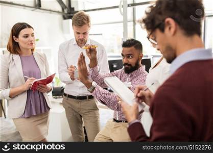 business, break, communication and people concept - happy creative team with notebooks discussing something at office. happy business team discussing something at office
