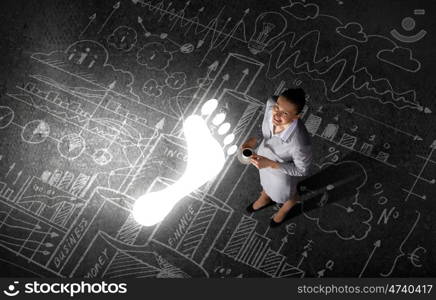 Business break. Top view of businesswoman with cup of coffee in hands