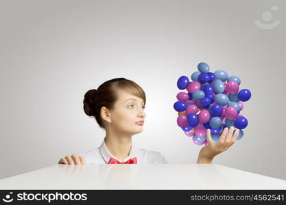 Business break. Young attractive businesswoman holding bunch of colorful balloons