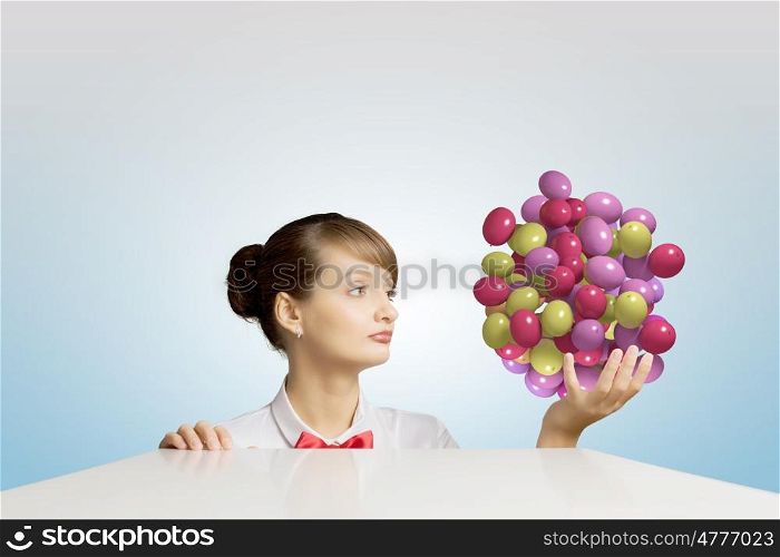 Business break. Young attractive businesswoman holding bunch of colorful balloons