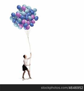 Business break. Young businesswoman pulling bunch of colorful balloons