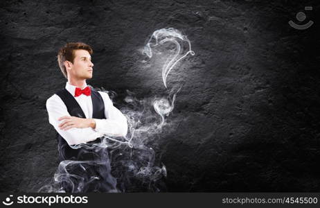 Business break. Young handsome businessman in fumes smoking pipe