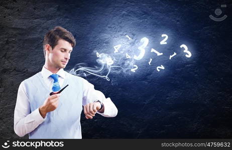 Business break. Young handsome businessman in fumes smoking pipe