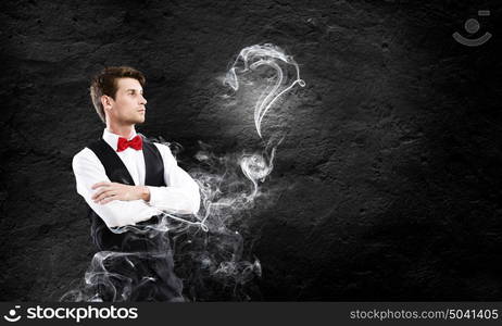 Business break. Young handsome businessman in fumes smoking pipe