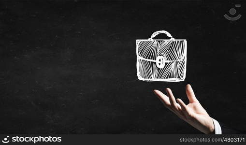 Business briefcase. Businessman hand holding chalk drawn briefcase on blackboard background