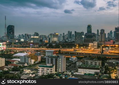 Business Building Bangkok city area at night life with transportation way, logistic concept high angle bird eyes view