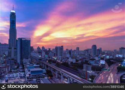 Business Building Bangkok city area at night life with transportation way, logistic concept high angle bird eyes view