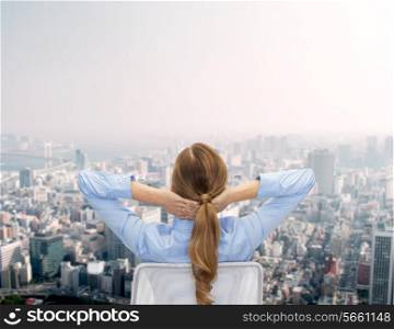 business, building, development and office people concept - businesswoman sitting on chair from back over city background